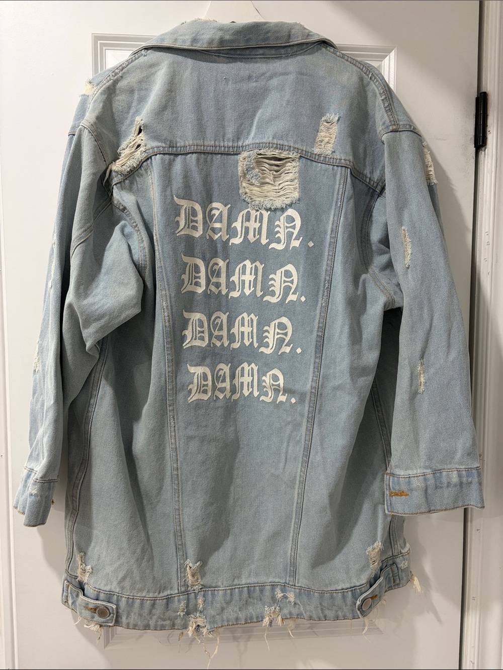 Light Blue Distressed Denim Jacket with 'DAMN.' Print